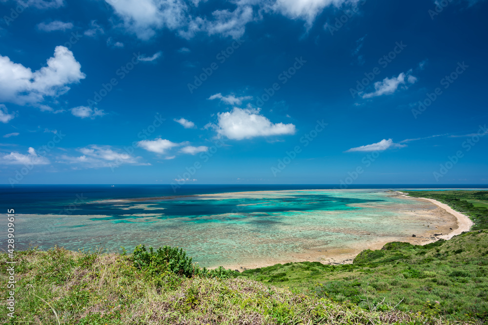 Incredible beach with ocean gradient colors, from light green to blue, full of coral reef, forming a beautiful in the maritime scene seen from above.
