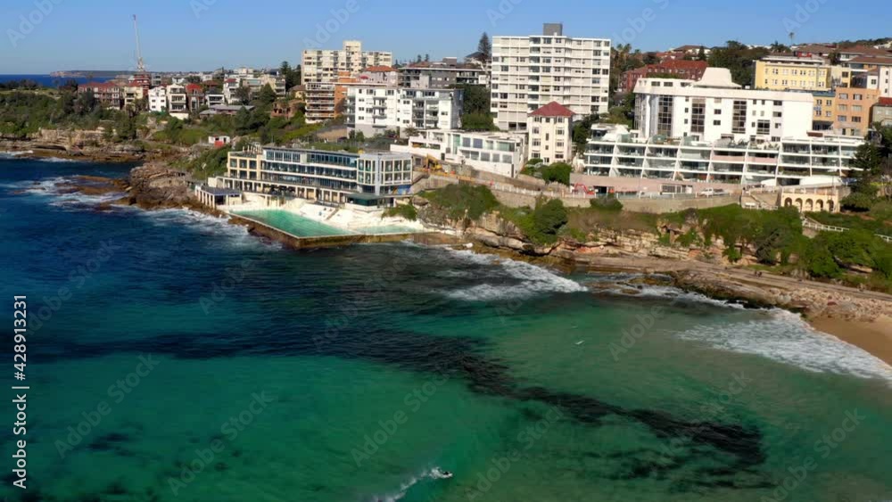 Scenic View Of Bondi Icebergs Pool And Bondi Icebergs Club. Oceanside Swimming Pool At Bondi Beach, NSW, Australia. aerial drone Scenic View Of Bondi Icebergs Pool And Bondi Icebergs Club. Oceanside Swimming Pool At Bondi Beach, NSW, Australia. aerial drone