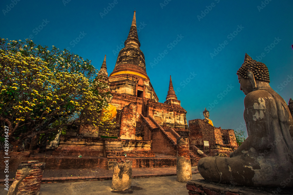 Fototapeta premium Background of old Buddha statues in Thai religious attractions in Ayutthaya Province, allowing tourists to study their history and take public photos.