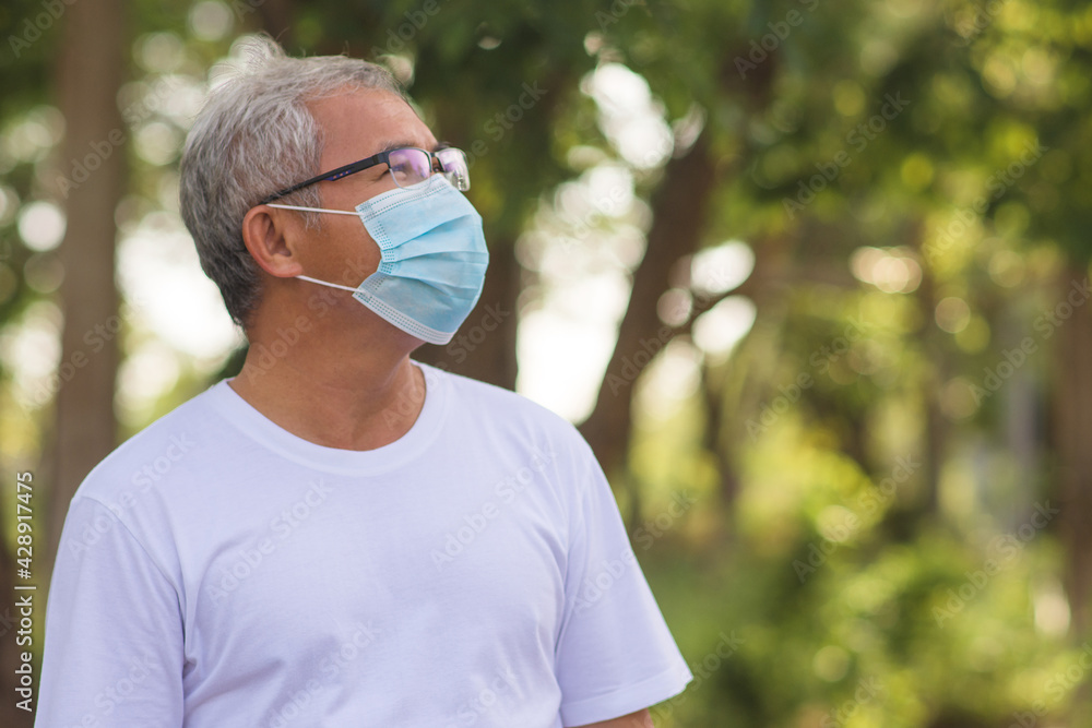 Old man wear surgical mask protect coronavirus covid19 at outdoor city park lifestyle new normal ,Retired man exercising in the morning Old man wear surgical mask protect coronavirus covid19 at outdoor city park lifestyle new normal ,Retired man exercising in the morning