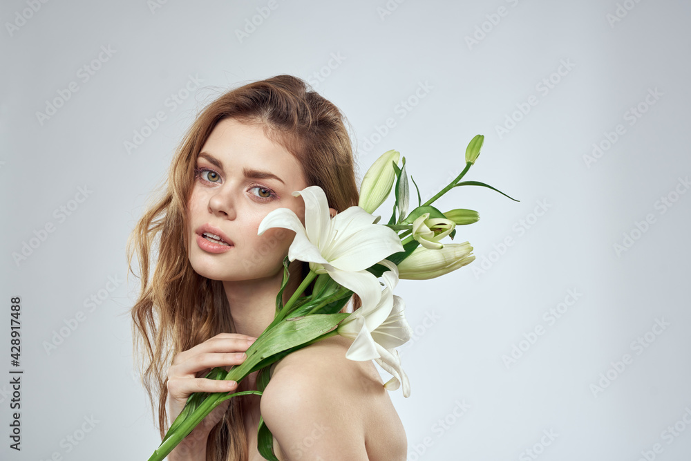 Charming lady with white flowers portrait close-up light background Charming lady with white flowers portrait close-up light background