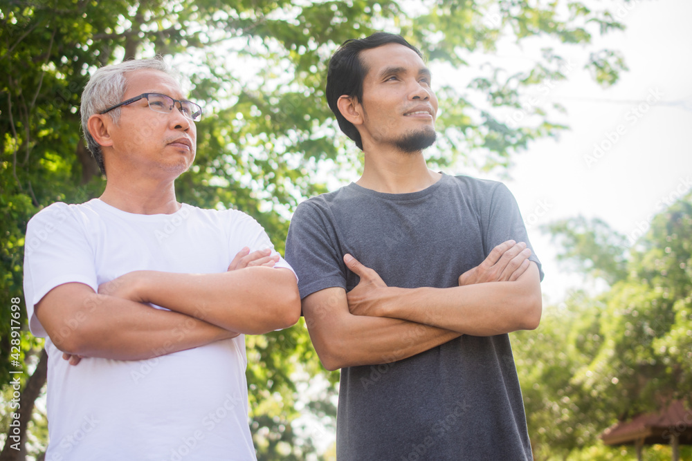 Two people old man and son exercise standing outdoor Two people old man and son exercise standing outdoor
