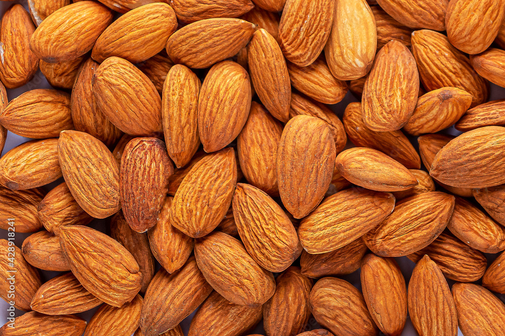 Pile of peeled almonds as texture background. Healthy vegetarian snacks. Protein-containing food Pile of peeled almonds as texture background. Healthy vegetarian snacks. Protein-containing food