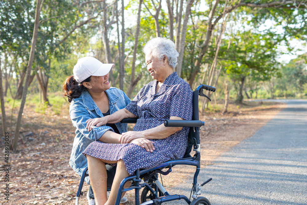 Asian senior or elderly old lady woman patient on wheelchair in park : healthy strong medical concept