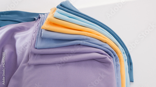 Rolls of bright colored fabric on a white background.