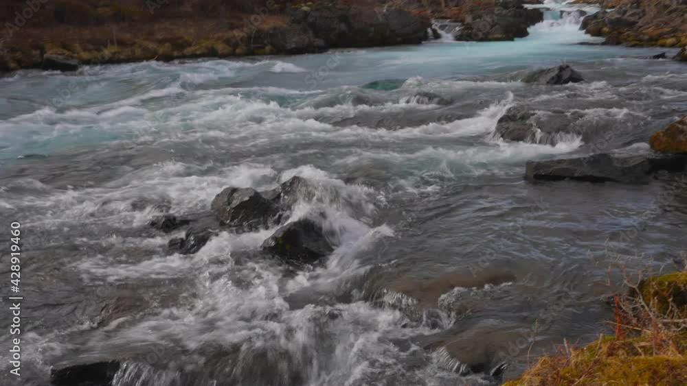 Rapid River Flow Rushing Through The Stones At River Bruara, Golden Circle, Southwest Iceland - tilt down shot Rapid River Flow Rushing Through The Stones At River Bruara, Golden Circle, Southwest Iceland - tilt down shot