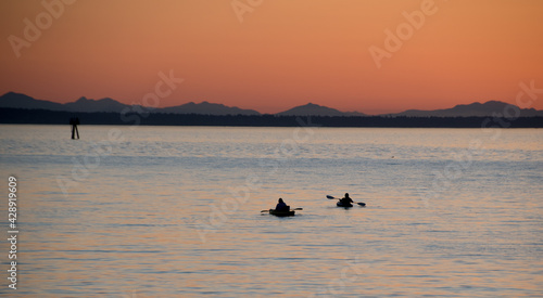 Watching kayaks at Semiahmoo Bay in the distant from Jorgensen Pier during sunset in Blaine Washington photo