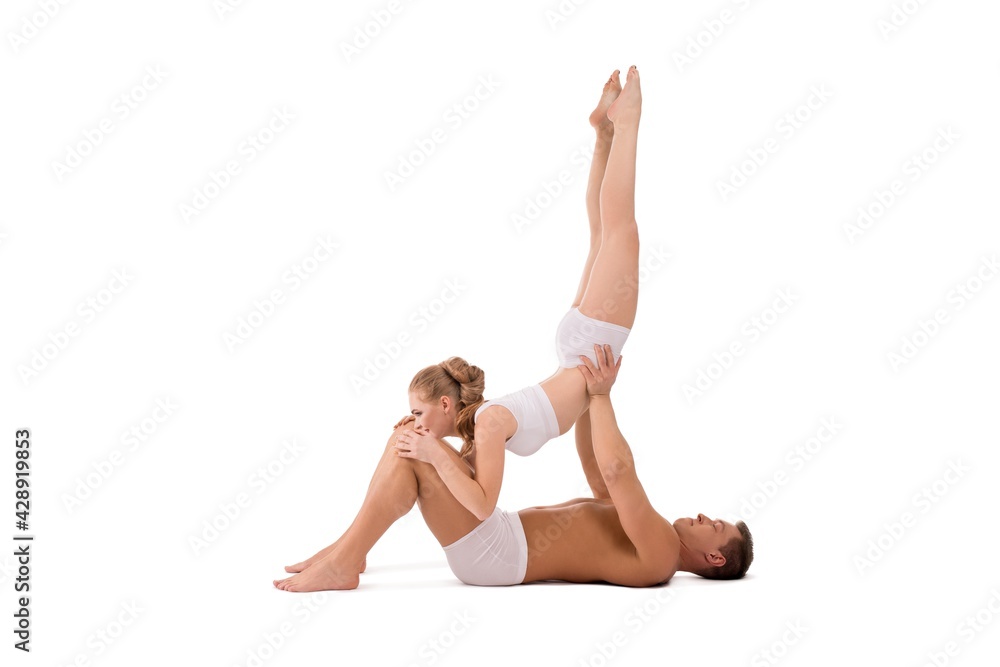 Male and female gymnasts in underwear exercising together Male and female gymnasts in underwear exercising together