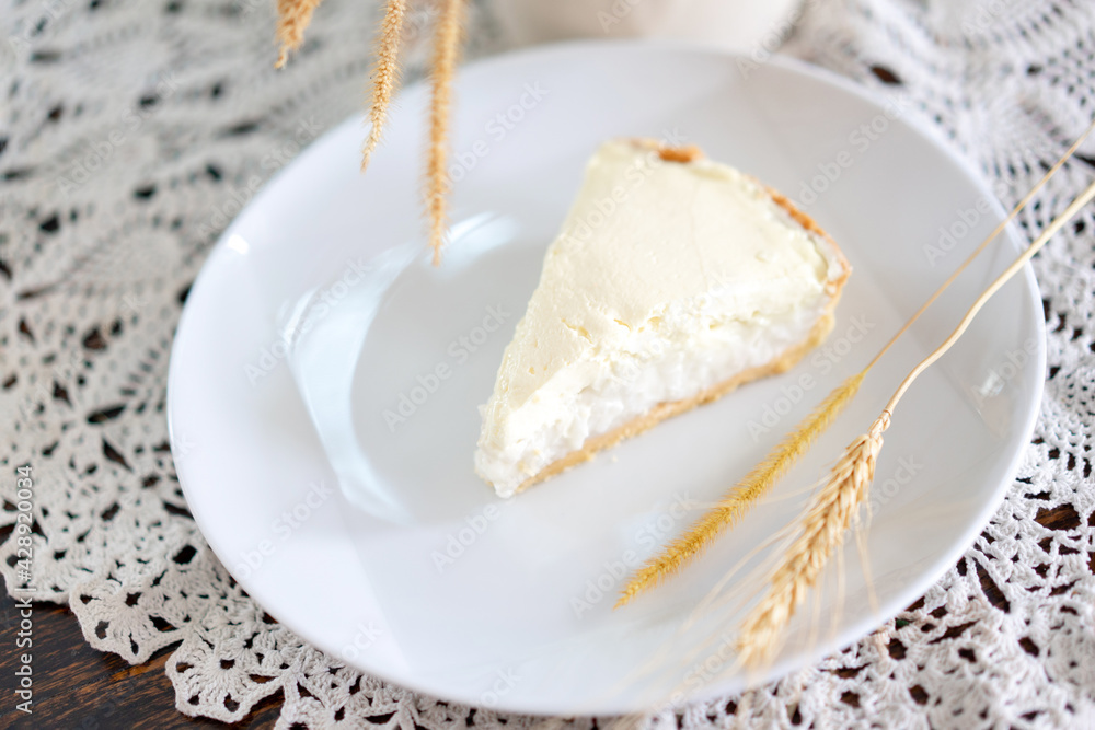 Clear Coconut Cream Pie in the dish on the wood table without anything topping on it. Shooting in the sunlight. Clear Coconut Cream Pie in the dish on the wood table without anything topping on it. Shooting in the sunlight.