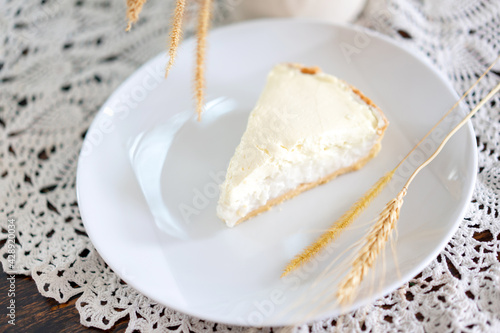 Clear Coconut Cream Pie in the dish on the wood table without anything topping on it. Shooting in the sunlight.
