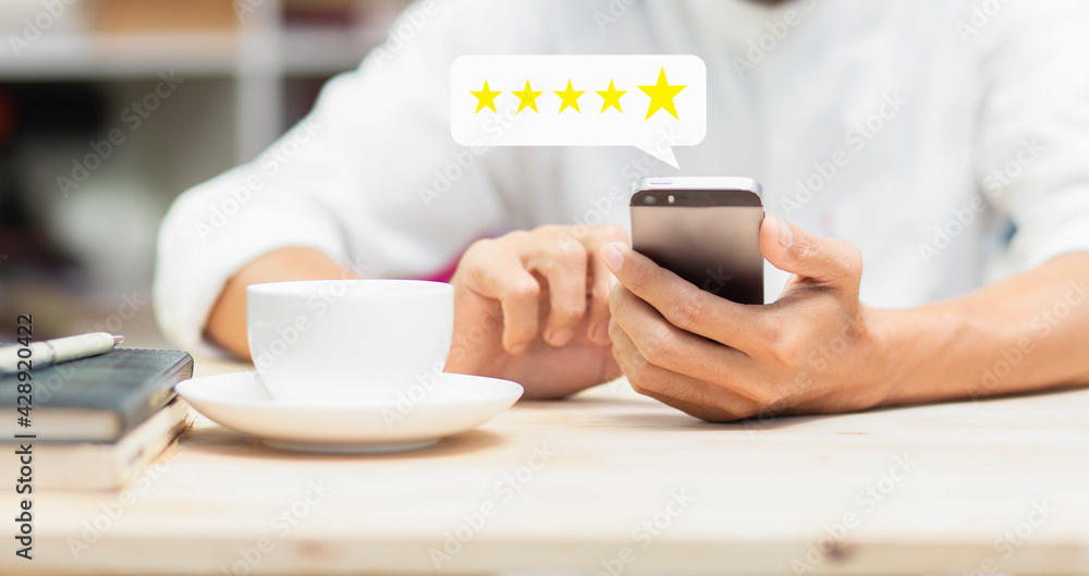 Customer pressing on smartphone with five star icon for feedback review satisfaction service Customer pressing on smartphone with five star icon for feedback review satisfaction service