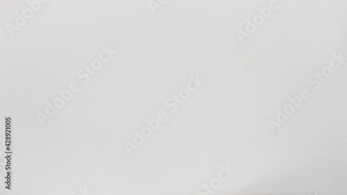 Woman's hand offers a Argentine pesos money fan in close-up and white background