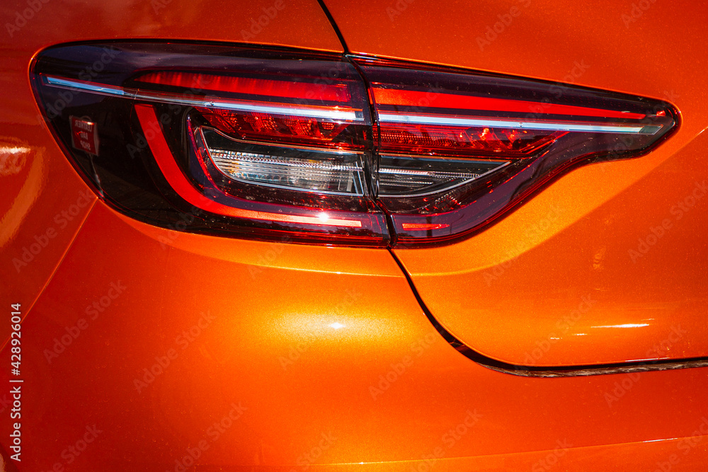 Orange car taillights. Exterior detail. Close up detail on one of the LED taillights modern car..