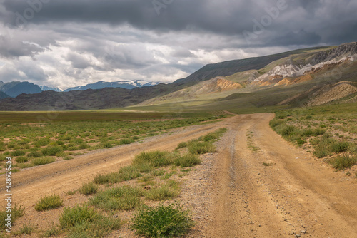 road steppe mountains clouds sky summer