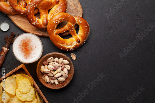 Lager beer, nuts, potato chips and fresh homemade pretzel