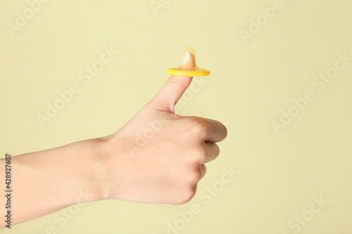 Female hand with condom sho...