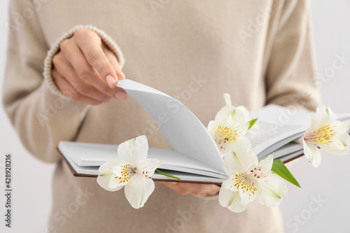 Woman holding book with fre...