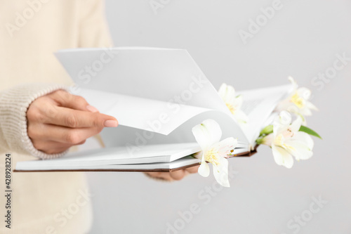 Woman holding book with fre...