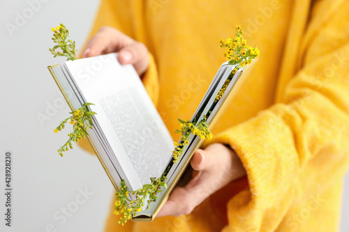 Woman holding book with fre...
