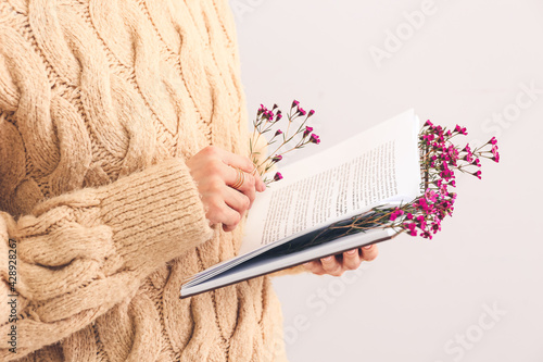 Woman holding book with fre...
