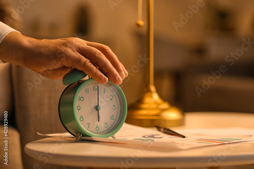 Mature man turning off alar...