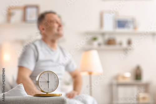 Alarm clock in room of mature man