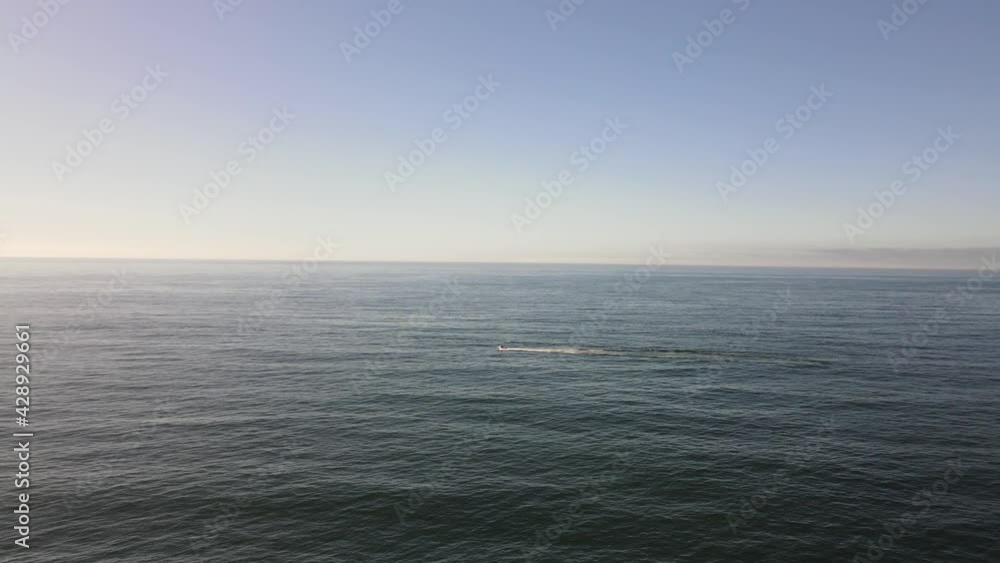 drone shot flying towards fishing boat in big open ocean drone shot flying towards fishing boat in big open ocean