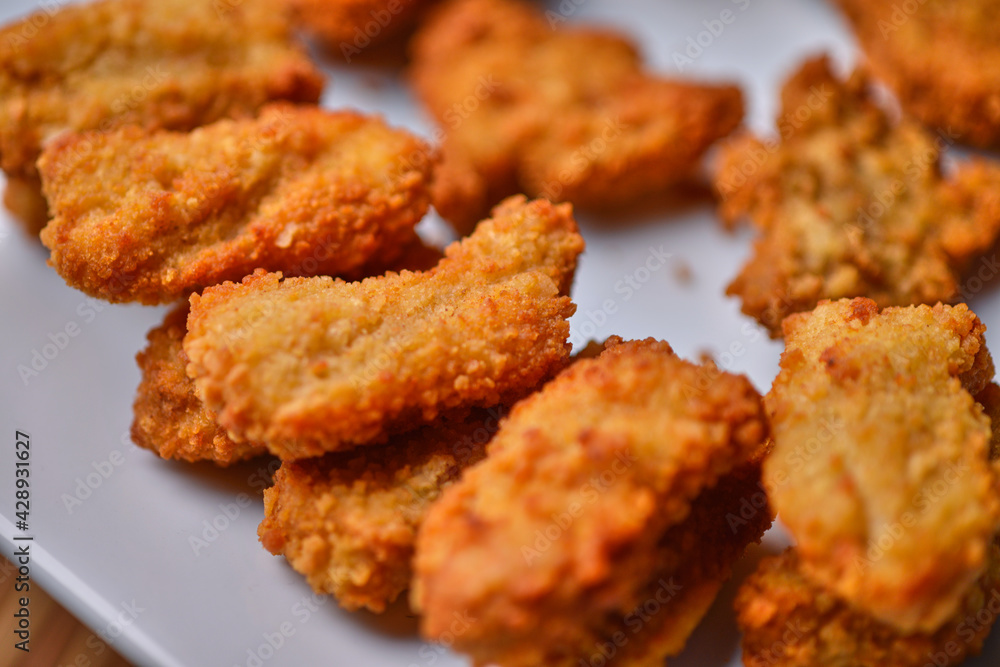 macro closeup of chicken nuggets snacks on white plate macro closeup of chicken nuggets snacks on white plate