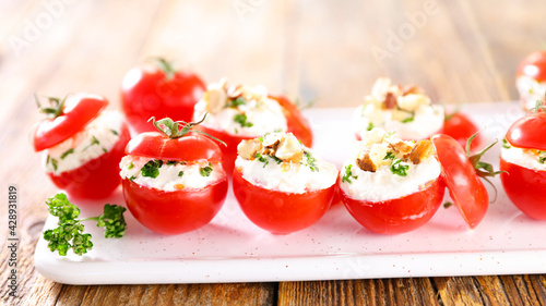 stuffed cherry tomato with cheese cream photo