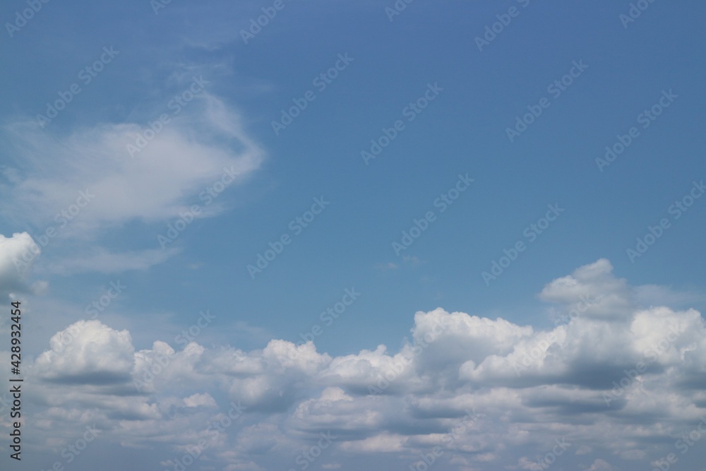 blue sky background with tiny clouds.