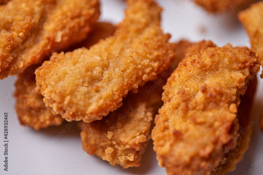 macro closeup of chicken nuggets snacks on white plate macro closeup of chicken nuggets snacks on white plate