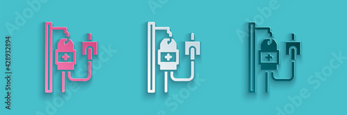 Paper cut IV bag icon isolated on blue background. Blood bag. Donate blood concept. The concept of treatment and therapy, chemotherapy. Paper art style. Vector