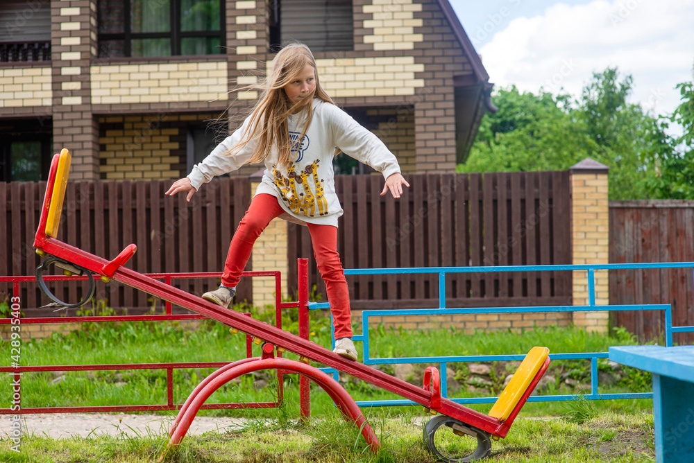 Fototapeta premium Happy childhood. Children on the playground, swing, selective focus