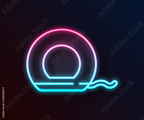 Glowing neon line Dental floss icon isolated on black background. Vector