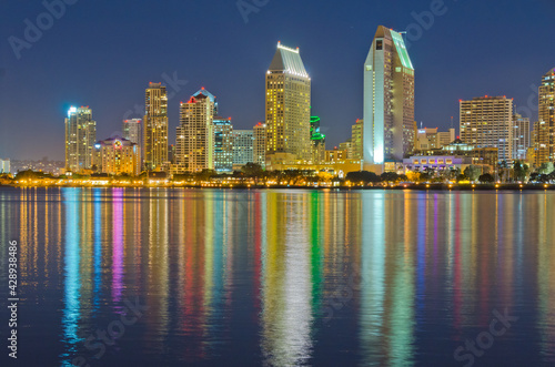 City at night, panoramic scene of downtown reflected in water, San Diego, CA, USA