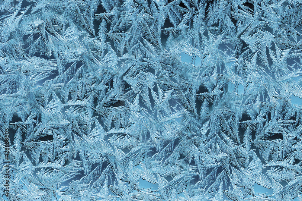 Textured patterns are drawn by frost on the windows of houses Textured patterns are drawn by frost on the windows of houses