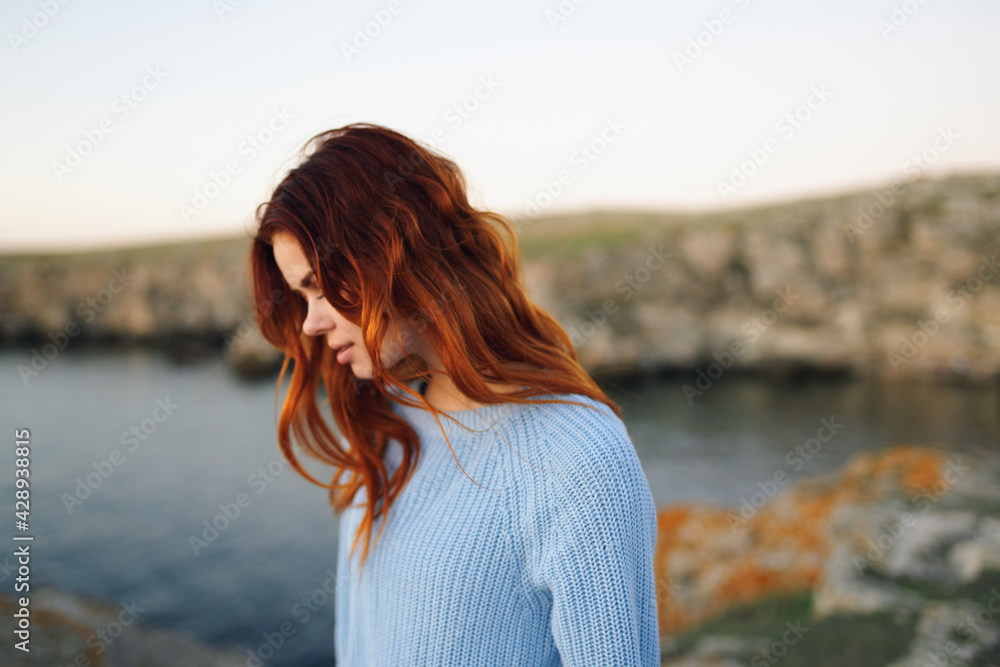 red-haired woman in sweater outdoors rocky mountains vacation red-haired woman in sweater outdoors rocky mountains vacation