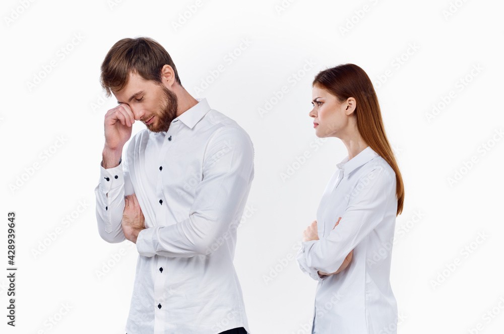 offended woman looks at from a returning man on a light background communication family misunderstanding offended woman looks at from a returning man on a light background communication family misunderstanding