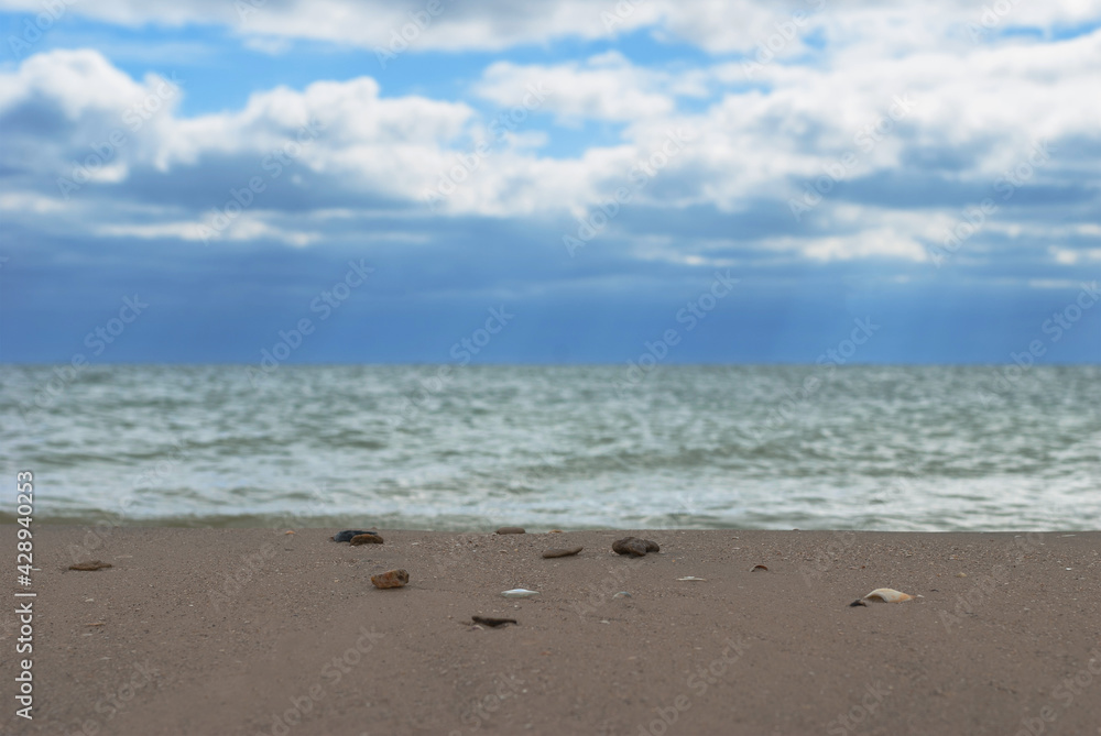 Cloudy sky over water surface and sandy shore. Cloudy sky over water surface and sandy shore.