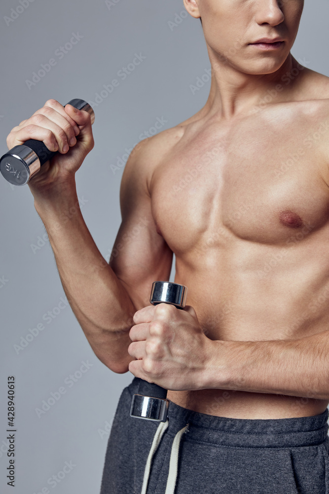 sporty man residual press with dumbbells in hands cropped view studio sporty man residual press with dumbbells in hands cropped view studio