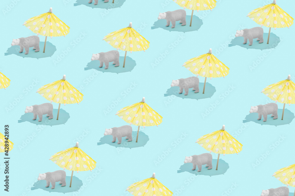 Minimal global climate change summer concept pattern with white polar bear sunbathing under an umbrella on bright blue background. Planet Earth melting and endangered species idea.