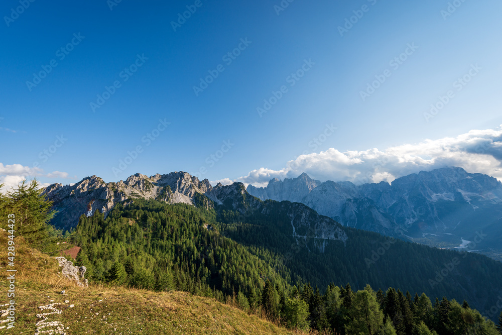 The Julian Alps seen from the Monte Santo di Lussari with the Cima del Cacciatore (Peak of the Hunter) and the mountain range of Jof di Montasio and Jof Fuart. Friuli Venezia Giulia, Italy, Europe.
