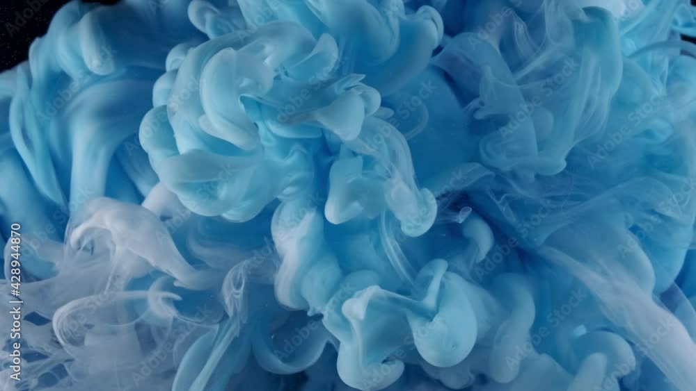 Blue and white acrylic paint mixed in water on abstract meditative background Blue and white acrylic paint mixed in water on abstract meditative background