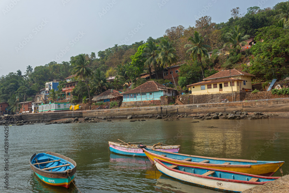 Beachside houses view and small boats parking on beach, Anjanvel, Konkan, Maharashtra, India.