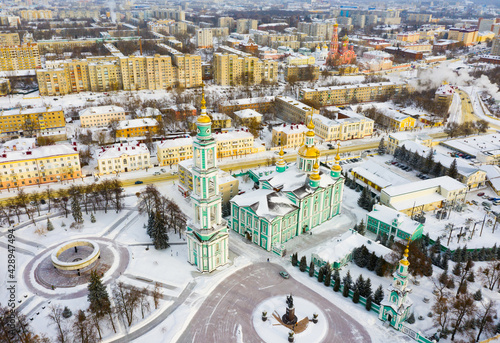 View from drone of Tambov Transfiguration Cathedral on background with cityscape on sunny winter day, Russia
