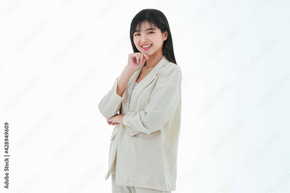 A young asian business woman has a big smile and place a finger close to her cheek, looking up to the side on copy space white background and thinking of something excited, delight and happiness A young asian business woman has a big smile and place a finger close to her cheek, looking up to the side on copy space white background and thinking of something excited, delight and happiness
