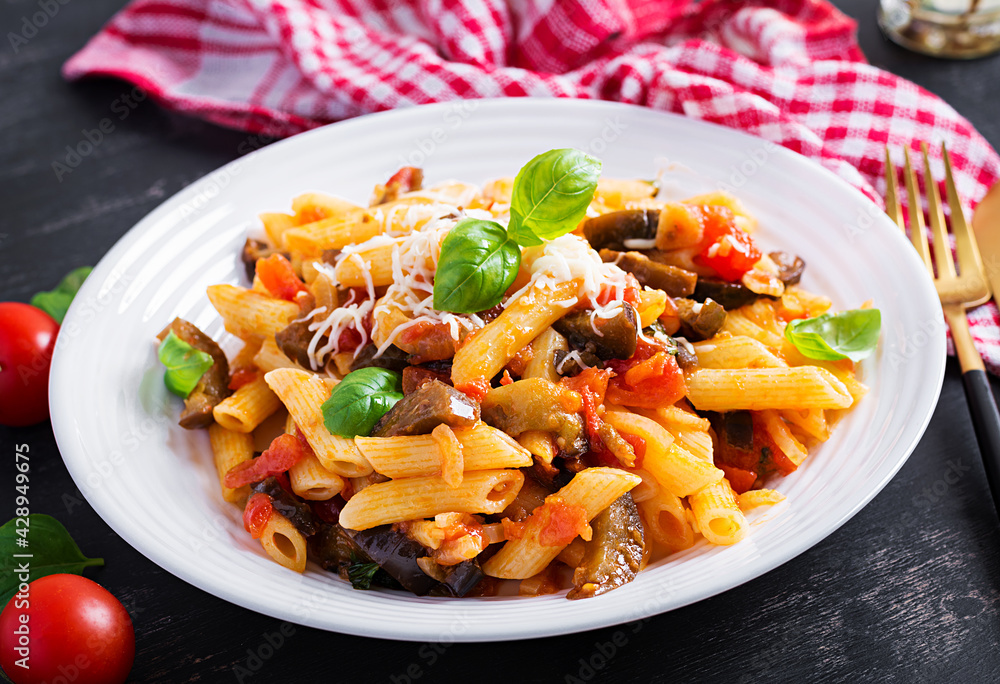 Pasta penne with eggplant. Pasta alla norma - traditional Italian food with eggplant, tomato, ricotta cheese and basil. Pasta penne with eggplant. Pasta alla norma - traditional Italian food with eggplant, tomato, ricotta cheese and basil.