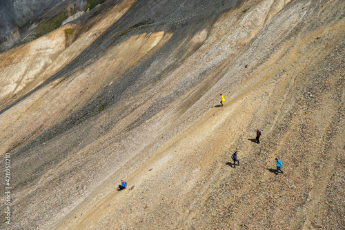  Hikers in volcanic mountains of Landmannalaugar in Fjallabak Nature Reserve. Iceland