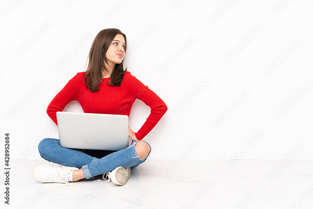 Tenaager girl working with pc isolated on white background posing with arms at hip and smiling Tenaager girl working with pc isolated on white background posing with arms at hip and smiling