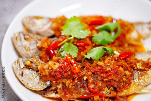 Deep fried fish and chili sauce on white plate delicious and favorite food in Thailand 